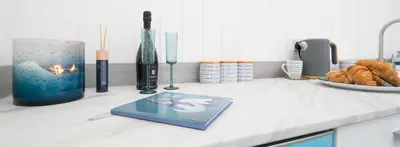 a kitchen counter with vases and a book on it at The Foresters Guest House in Inverkip