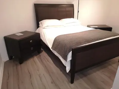 a bedroom with a large bed and two night stands at Glasgow Hampden Garden Flat in Glasgow