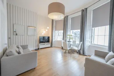 a living room with a couch and a table at Edinburgh Castle Apartments in Edinburgh