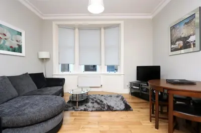 a living room with a couch and a table at Dreamhouse Apartments Glasgow St Vincent Street in Glasgow