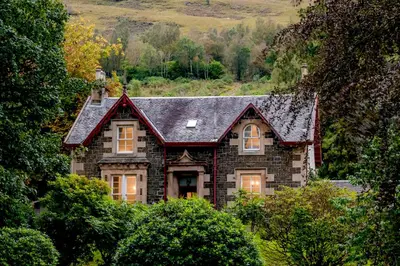 a house with a slate roof on top of trees at Mansefield House in Arrochar