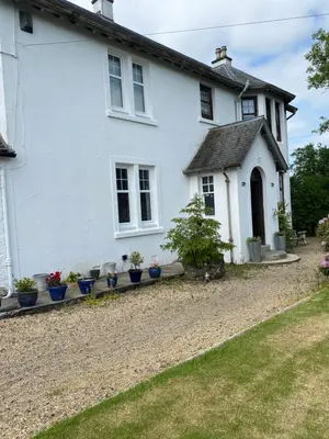 a white house with potted plants in front of it at Fox House Thirdpart Farm in Beith