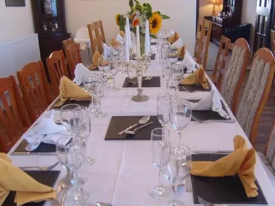 a long table with glasses and napkins on it at Telford Manor House in Beattock