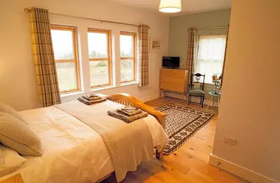 a bedroom with a bed with two towels on it at Ceo Mara Croft b&b & 2 luxury Cabins in Taynuilt