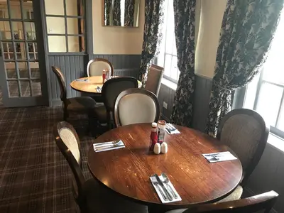 a dining room with two tables and chairs at The Inn at Kippen in Kippen