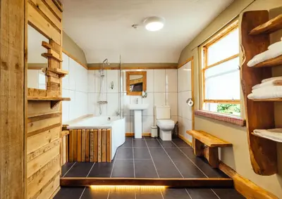 a bathroom with a tub and a toilet and a sink at The Inn at Kippen in Kippen