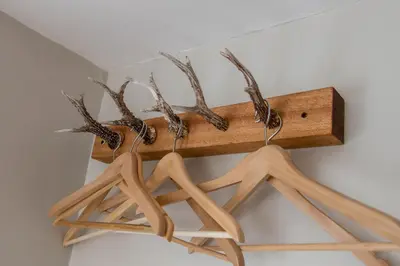 a wooden rack with antlers on a wall at The Inn at Kippen in Kippen