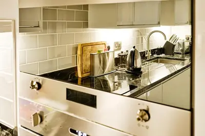 a kitchen with a counter top and a sink at JOIVY Luxury Flats on George Street in Edinburgh