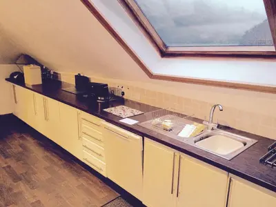 a kitchen with a sink and a skylight at The Boathouse in Glencoe