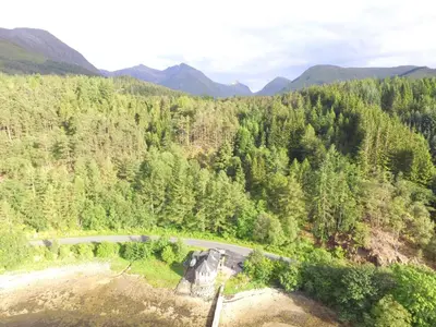 an aerial view of a road in a forest at The Boathouse in Glencoe