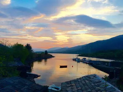 a view of a river with boats on it at sunset at Park View in Ballachulish
