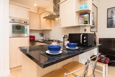 a kitchen with a counter with two blue bowls on it at Luxury New Town 1 Bed Apartment in Edinburgh