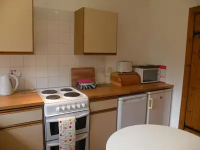 a kitchen with a stove and a counter top at McHugh and Loudon Cottages in Saint Catherines