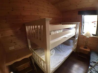 a bedroom with two bunk beds in a log cabin at Lochlomondlodge22 in Rowardennan