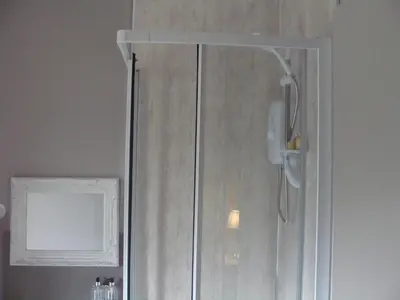 a shower with a glass door in a bathroom at Riggend Farm Accomodation in Airdrie