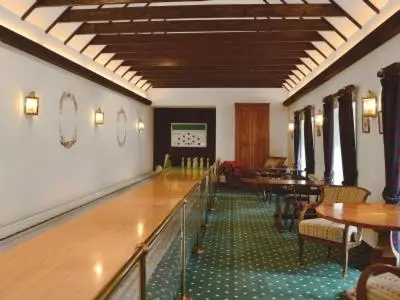 a room with tables and chairs in a restaurant at Hearthstanes Steading in Polmood