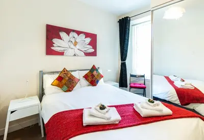 a bedroom with two beds with towels on them at Mycosyapartments54 in Paisley