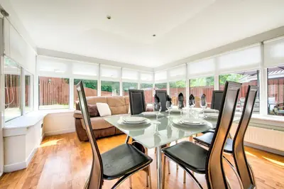 a dining room with a table and chairs at No.17 Serviced Apartment in Glasgow