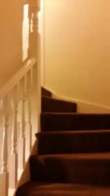 a set of stairs with a light shining on them at Livingston Ideal commuter House in Livingston