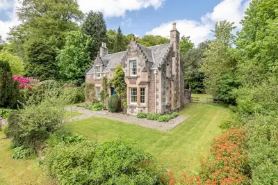an old house with a garden in front of it at Gardener's Cottage in Crieff