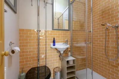 a bathroom with a glass shower and a sink at Gardener's Cottage in Crieff