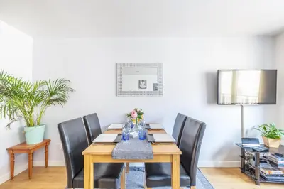 a dining room with a wooden table and chairs at Cosy Apartment in Quiet City-Centre with Car Park in Glasgow