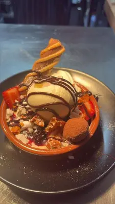 a plate of food with ice cream and other foods at Pond Cottage in Covington