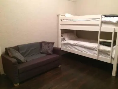 a living room with a couch and a bunk bed at The Haven Cottage in Slamannan