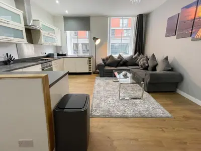 a living room with a couch and a table at Exquisite 2BR Flat near Central Train Station in Glasgow
