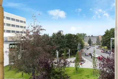 a view of a street in a city with a building at Townhead Apartments Gallery View in Paisley