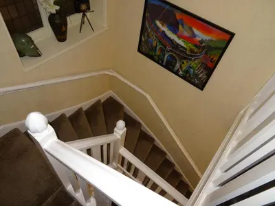 a painting on the wall above a stairway at The Knowe Guest House in Callander