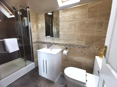 a bathroom with a toilet and a sink and a shower at The Knowe Guest House in Callander