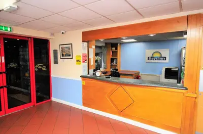 a restaurant with a cash counter in a room at Days Inn Hamilton in Hamilton