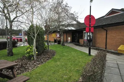 a park with a bench and a building at Days Inn Hamilton in Hamilton