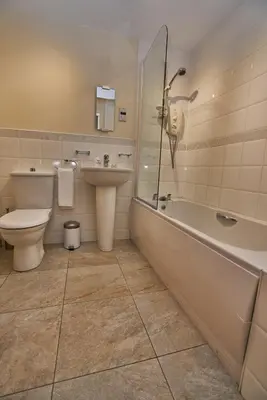 a bathroom with a toilet and a tub and a sink at Edinburgh Pearl Apartments - Haymarket Residence in Edinburgh