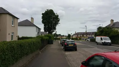 a row of cars parked on the side of a street at Montgomery Apartments - Stevensons in Edinburgh