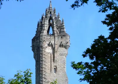 a tall stone tower with a turret on top at Stirling Court Hotel in Stirling