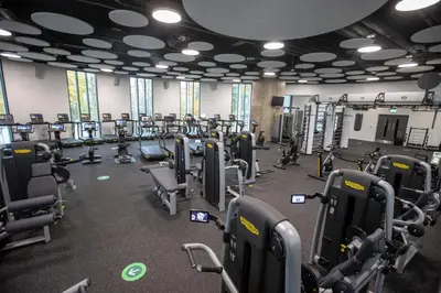 a gym with a lot of treadmills and machines at Stirling Court Hotel in Stirling