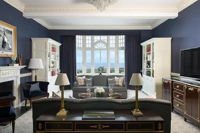 a living room with a couch and a tv at Trump Turnberry in Turnberry