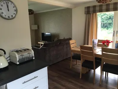 a living room with a couch and a table at Bruce's Cottage in Stirling