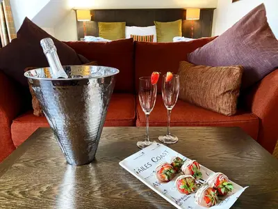 a table with two wine glasses and food on it at The Loans Inn in Troon