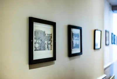 a group of framed pictures hanging on a wall at The Crown in Callander