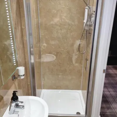 a bathroom with a shower and a sink at Rose Villa in Oban