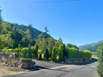a road in the mountains with a hedge at The Heron in Ardentinny