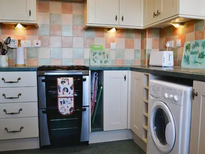a kitchen with a stove and a dishwasher at Ferry View in Oban