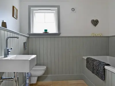 a bathroom with a toilet and a sink at Geordies Byre in Mill of Fortune