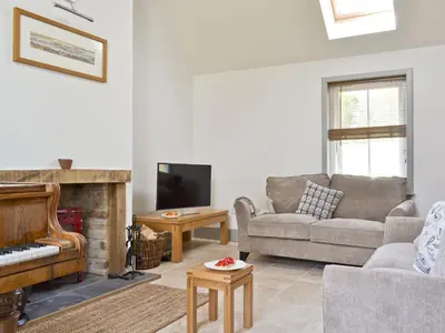 a living room with a couch and a fireplace at Ben Hennie in Mill of Fortune