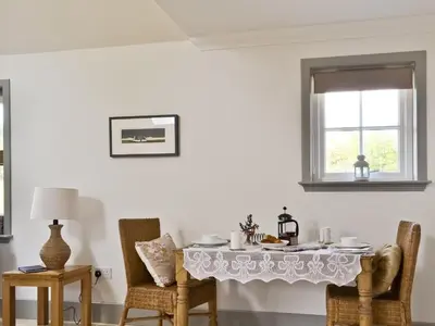 a dining room with a table and chairs at Ben Hennie in Mill of Fortune