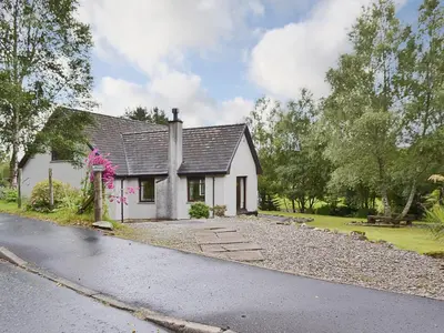 a white house on the side of a road at Bethany Cottage in Aberfoyle