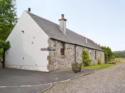 an old stone building with a window on the side at Old Stones in Glendevon